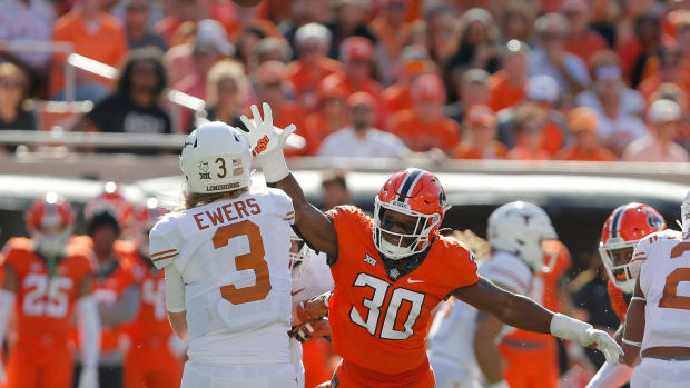 Oklahoma State Cowboys defensive end Collin Oliver (30) puts pressure on Texas Longhorns quarterback Quinn Ewers (3) during a college football game between the Oklahoma State Cowboys (OSU) and the University of Texas